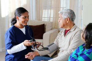 caregiver monitoring patients blood pressure