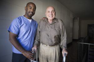 caregiver assisting his patients in walking